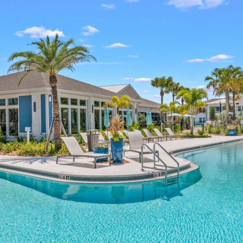 Resort-style swimming pool with lounge seating at Vida Lakewood Ranch