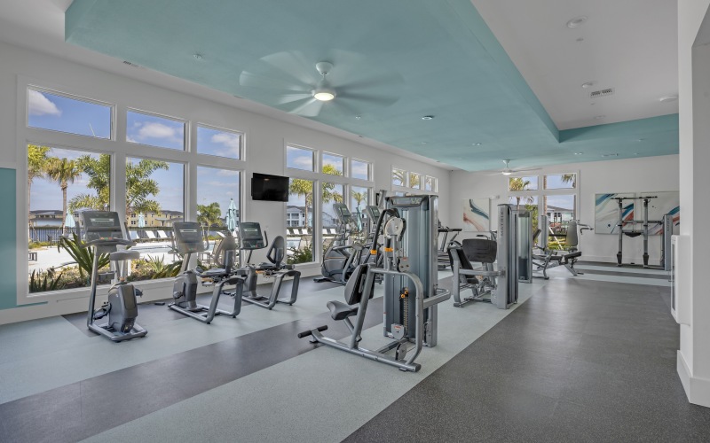 Large windows in fully-equipped fitness center at Vida Lakewood Ranch
