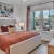 Furnished apartment bedroom with natural lighting and high ceilings at Vida Lakewood Ranch